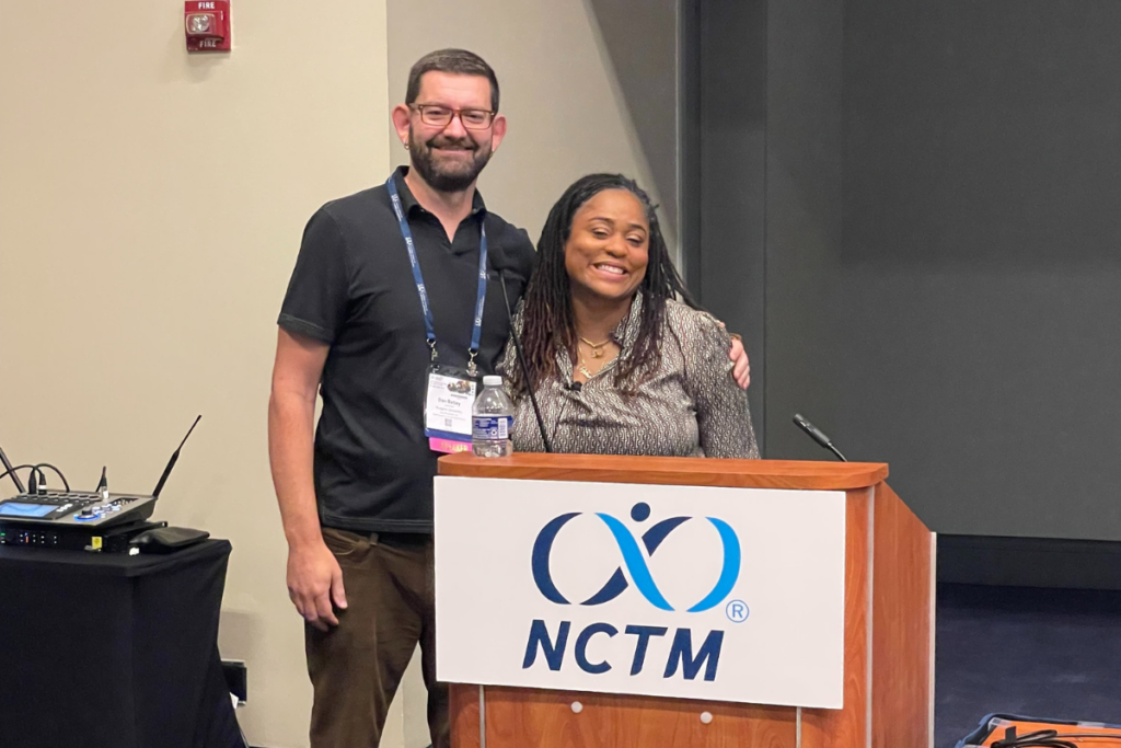 Dr. Dan Battey and Dr. Brittany Marshall smiling behind a podium.